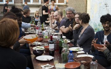 People gathering for a community dinner outside