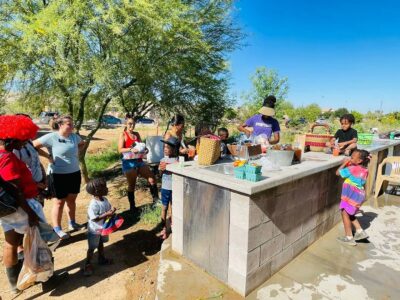 Spaces of Opportunity volunteers and gardeners clean off their fresh produce. Credit: Unlimited Potentital