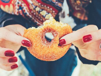 Image of a hand holding a doughnut