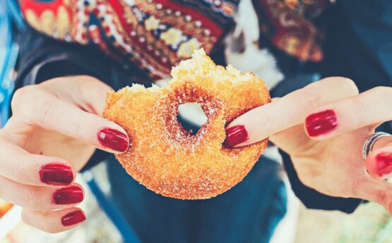 Image of a hand holding a doughnut